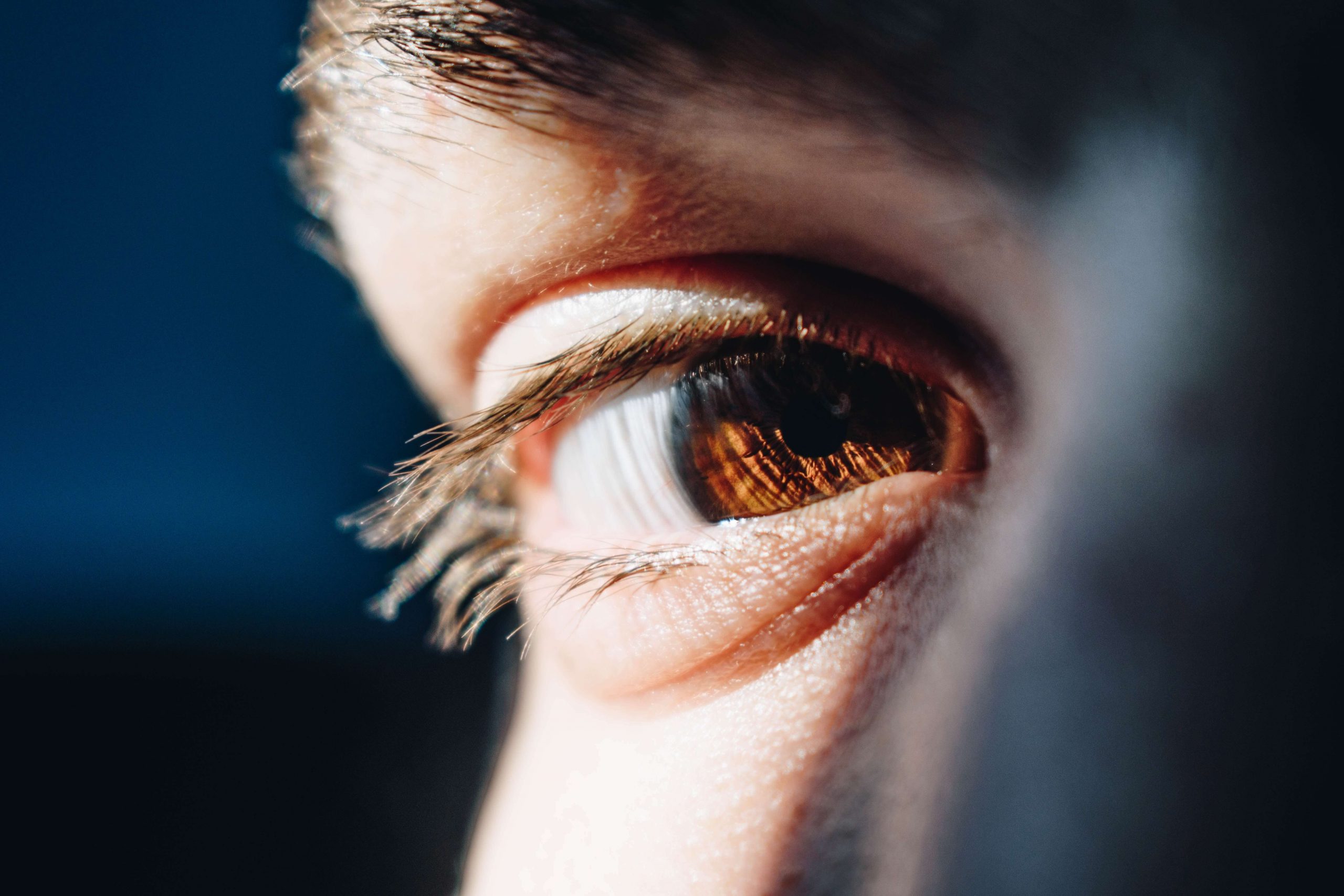 Closeup image of a man's face showing his brown eye. Do you struggle with anxiety? Discover how EMDR therapy in Denver, CO can help you overcome your symptoms.