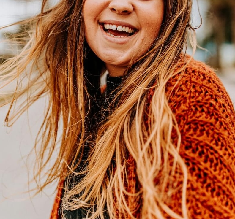 Image of a smiling teen girl twirling outside. Find helpful solutions to your teen with the help of teen counseling in Denver, CO.
