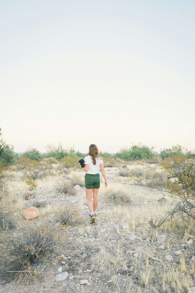 Image of a woman walking through a desert at dusk. Learn to manage your anxiety, ADHD, Autism, and more with neurofeedback therapy in Denver, CO.