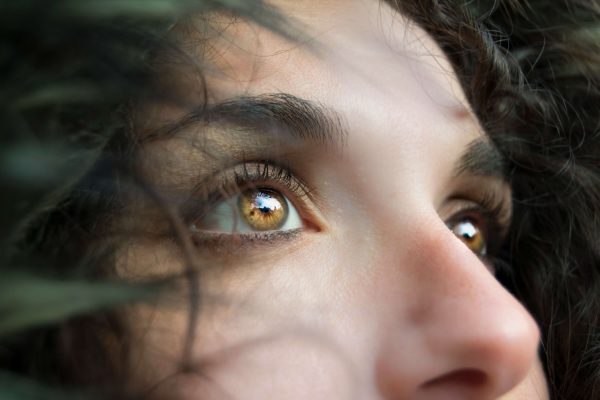 Image of a woman with yellow eyes and brown hair looking up. Discover the benefits of EMDR therapy via Telehealth therapy in Colorado.