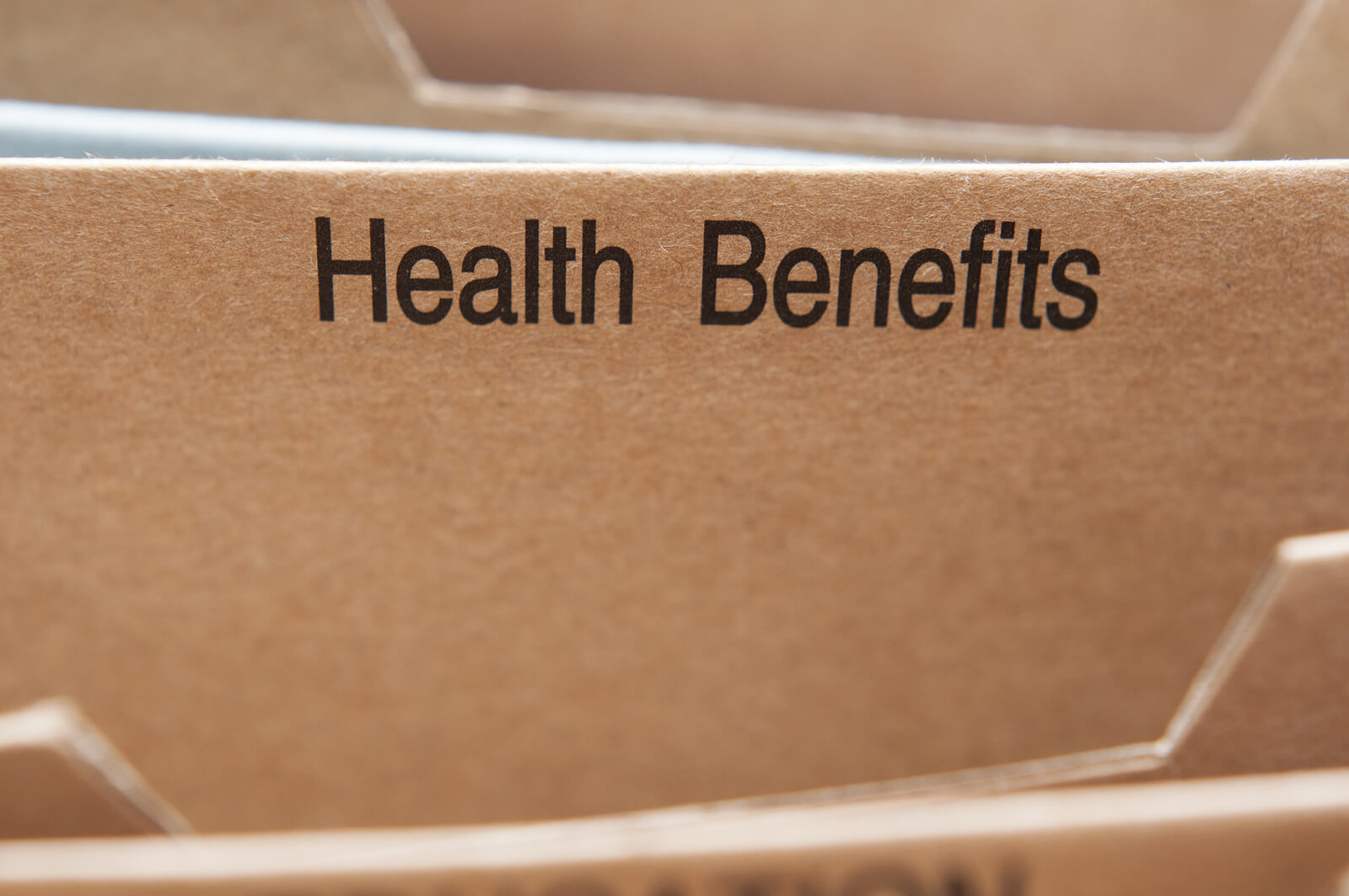 A close-up of a folder labeled “Health Benefits,” symbolizing coverage for online therapy that takes insurance, including ADHD therapy in Littleton, CO and anxiety treatment. 