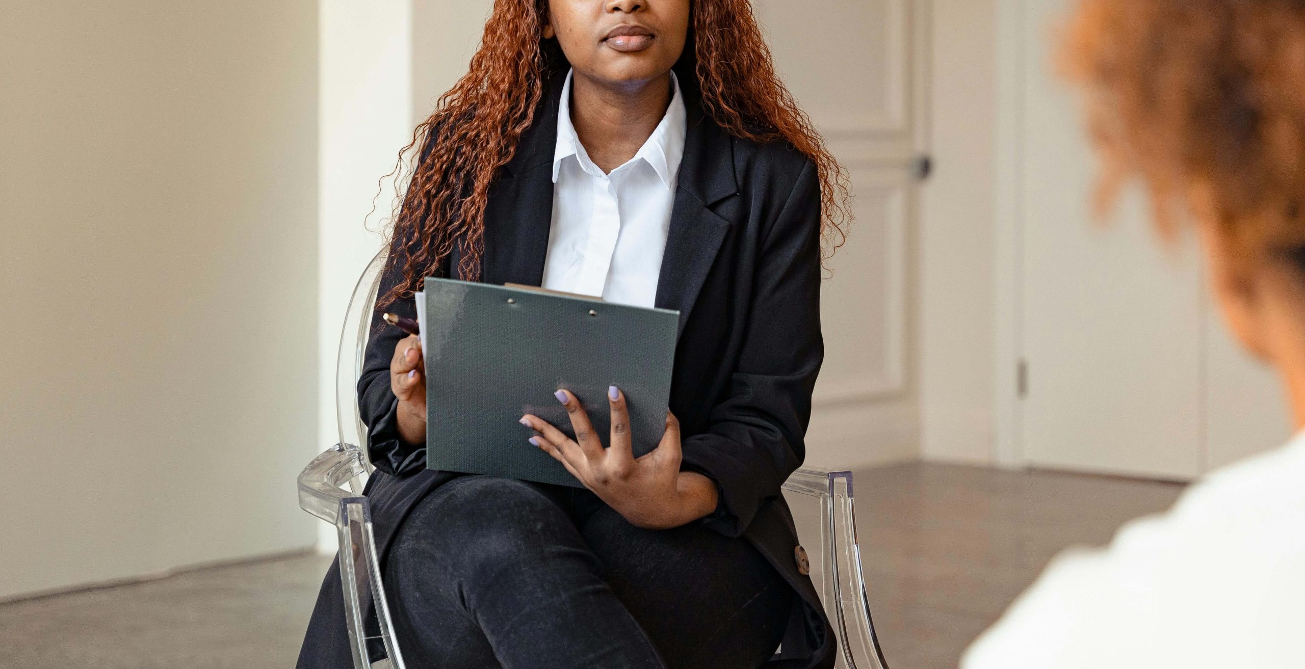 A compassionate therapist listens attentively to a client, illustrating personalized care through online therapy that takes insurance, especially for anxiety and ADHD in Colorado. 