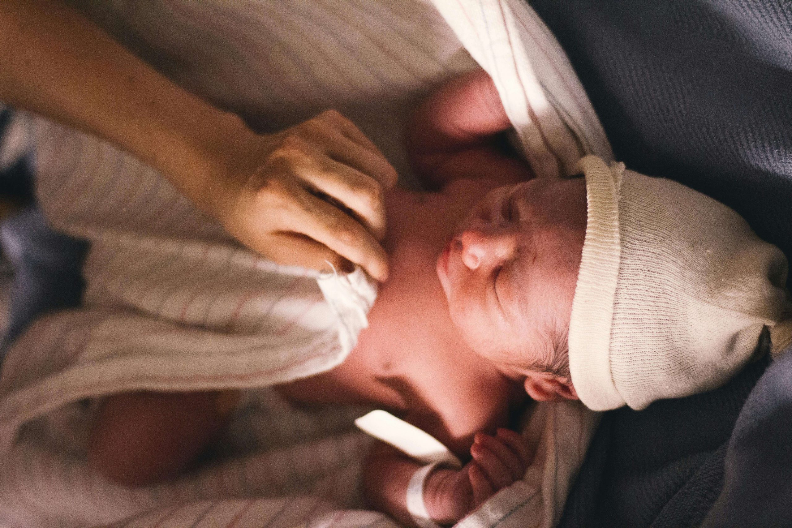 A newborn baby rests in a blanket, symbolizing the need for therapy for new moms and postpartum therapist support through online therapy in Colorado and online therapy that takes insurance. 