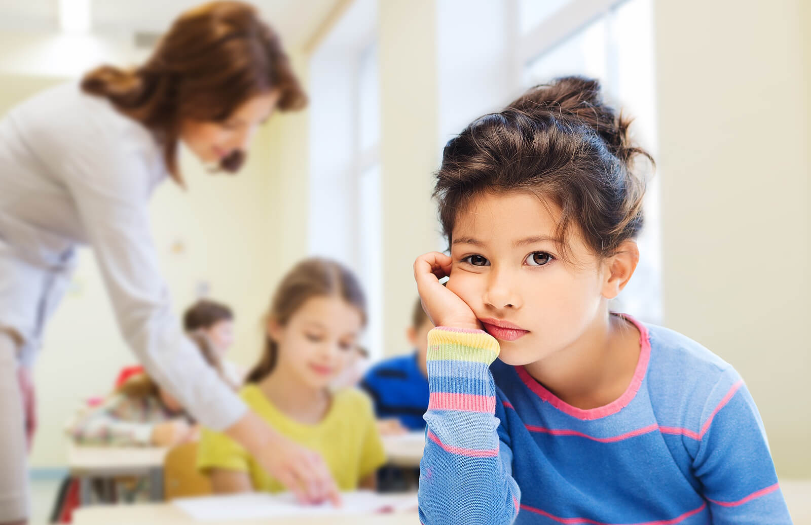 Child looking distracted in a classroom, illustrating when parents might seek adhd testing in Greenwood Village, CO, adhd testing in Denver, adhd testing in Littleton, CO, or support from a child therapist in Englewood, CO. 