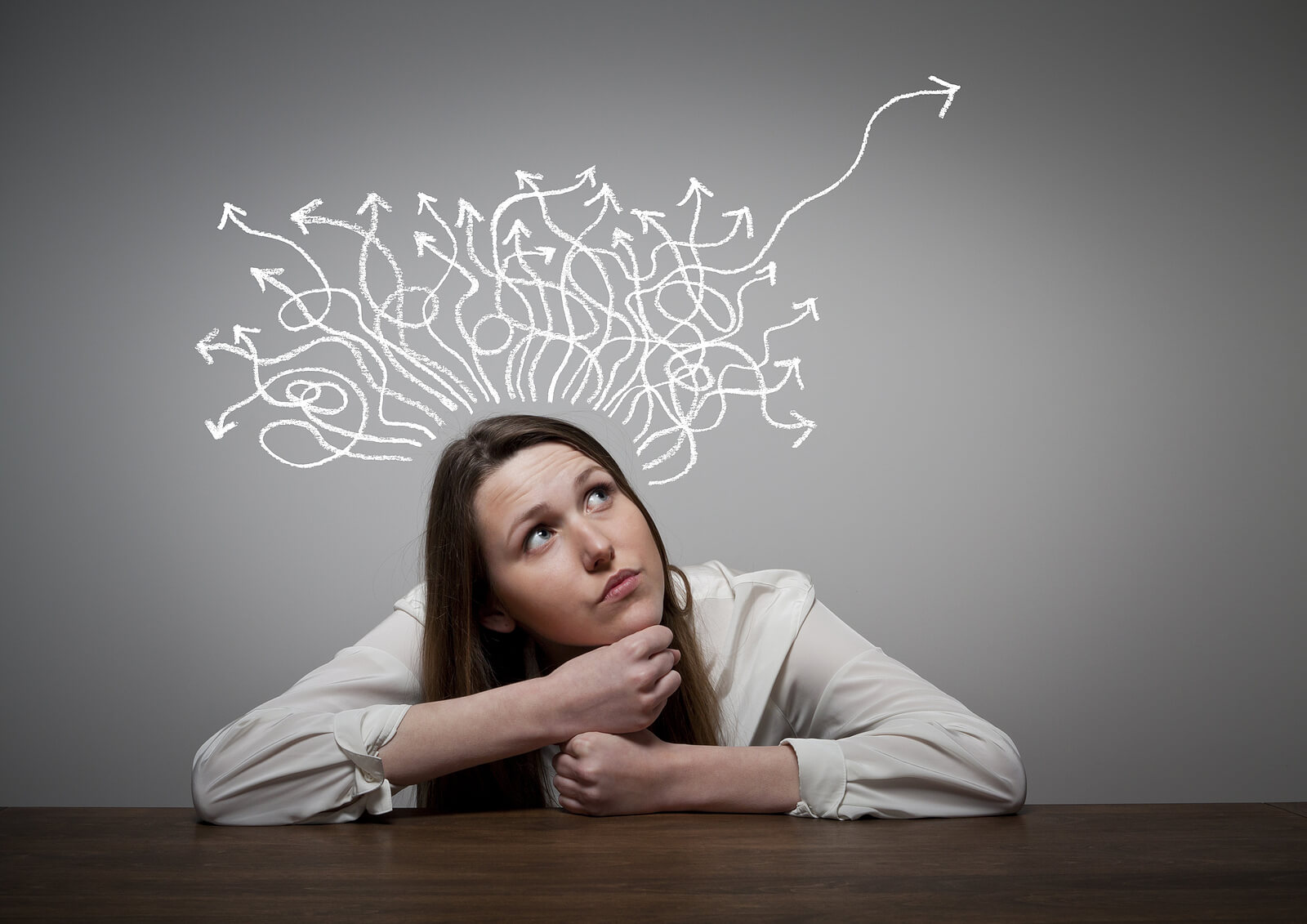 Woman gazing up as tangled arrows turn into a clear path, representing clarity after assessment. Ideal for discussing autism in women littleton, co, steps toward adult autism diagnosis denver, and comprehensive autism evaluation denver. 