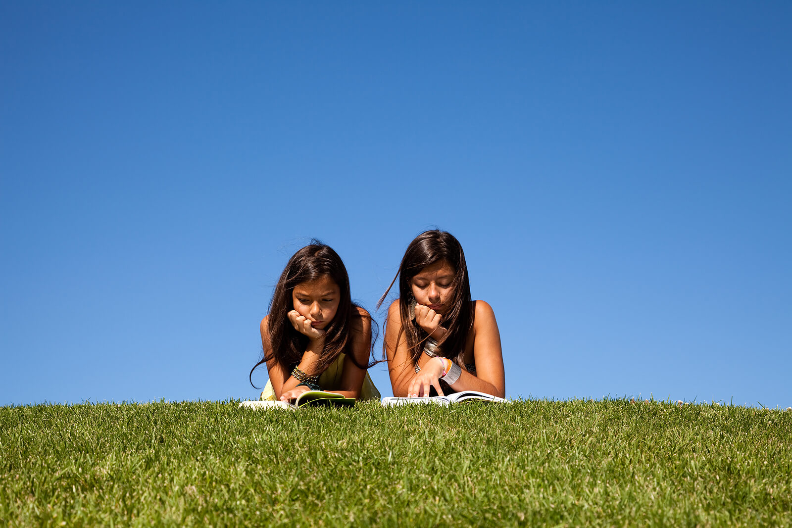 reading in park | child therapist in englewood, co | child therapy in littleton, co | learning disability evaluation in denver, co | denver, co | littleton, co | englewood, co | greenwood village, co Two girls lie side by side on a grassy hill, reading books together under a bright blue sky. This kind of relaxed engagement with reading can become possible for children who receive the right support following child therapy in Littleton, CO. For children who have struggled with reading or other academic tasks, a learning disorder test in Littleton, CO can open the door to a very different experience with learning.