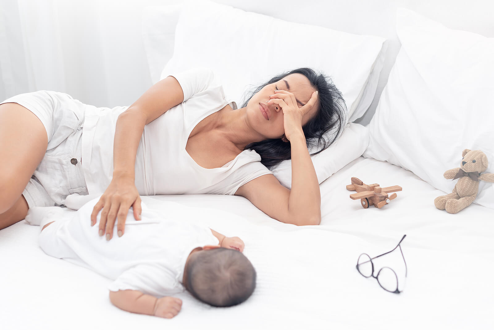 tired new mother | anxiety therapist in englewood, co | anxiety therapy in englewood, co | postpartum therapist near me | englewood, co | greenwood village, co | littleton, co An exhausted new mother lies beside her newborn with her hand over her face, capturing the overwhelming fatigue and emotional strain that postpartum anxiety can bring. A postpartum therapist can help mothers work through these feelings and rebuild a sense of stability and connection with their baby. If you're searching for a postpartum therapist near me, know that support through postpartum anxiety therapy in Greenwood Village, CO is available and can make a real difference.